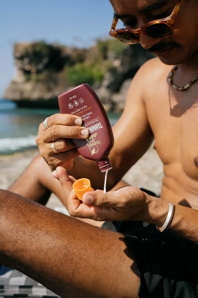 Hawaiian Style Coconut Tanning Oil poured into an open palm